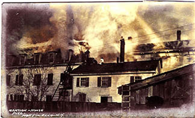 Mansion House (current site of the Heritage Inn), at Main and Jones streets (Main Street now called Broadway), as it was engulfed in flames on August 10, 1909.